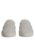 Chaussures mocassins Dolce & Gabbana blanches en dentelle florale, style slip-on, élégantes et sophistiquées pour femmes.