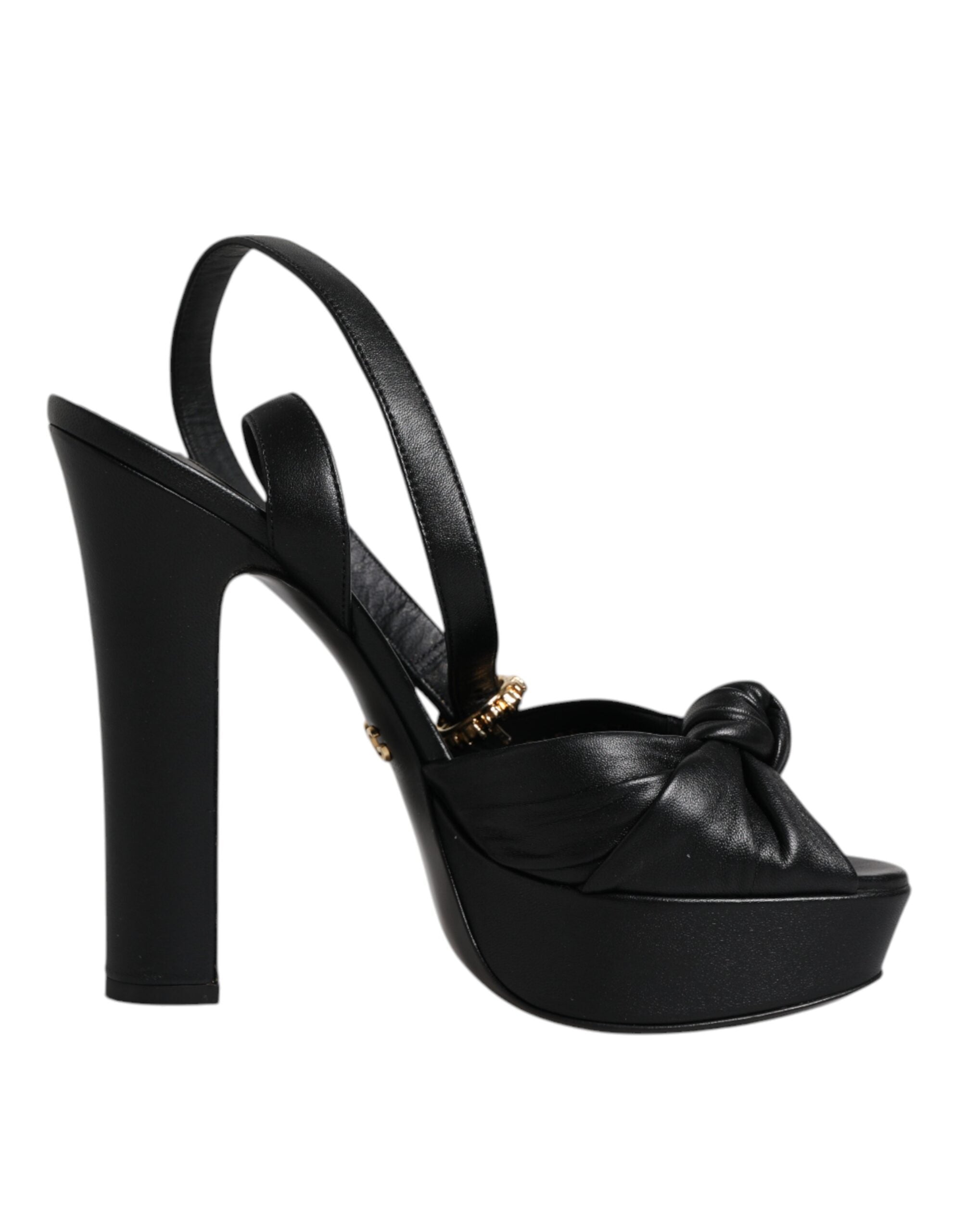 Sandales à talons compensés en cuir noir de Dolce & Gabbana, avec plateforme et détails élégants visibles sur la photo.