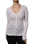 Cardigan blanc en soie Dolce & Gabbana avec boutons, porté ouvert, détail élégant et texture douce visible sur l'image.