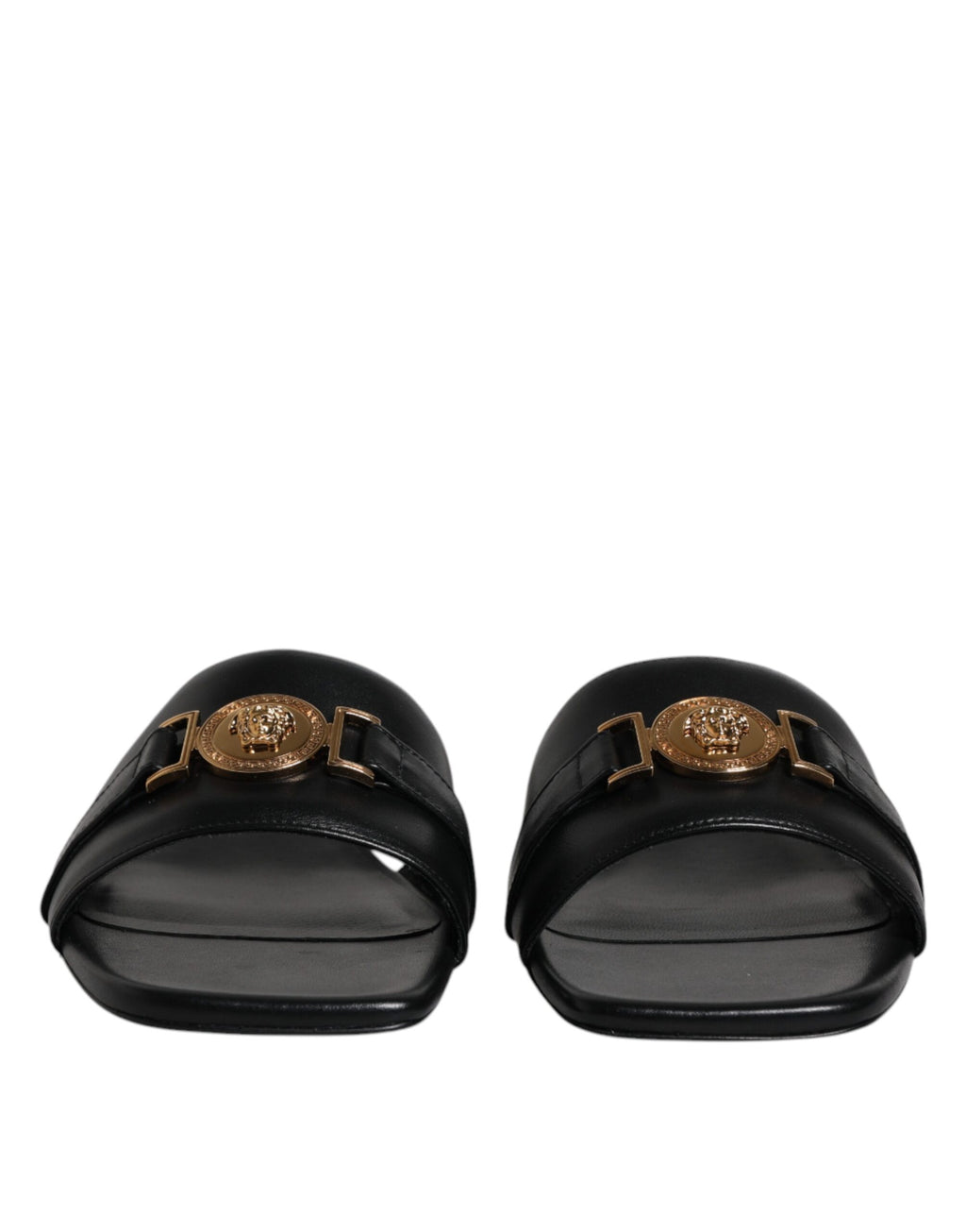 Chaussures plates slip-on en cuir noir Versace avec plaque logo, style élégant et confortable pour homme.