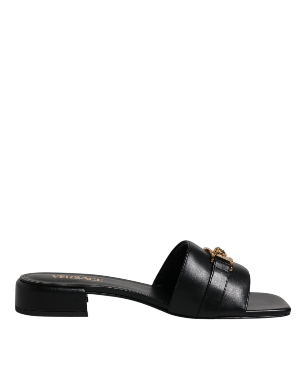 Chaussures plates slip-on Versace en cuir noir avec plaque logo, style élégant et confortable pour homme.