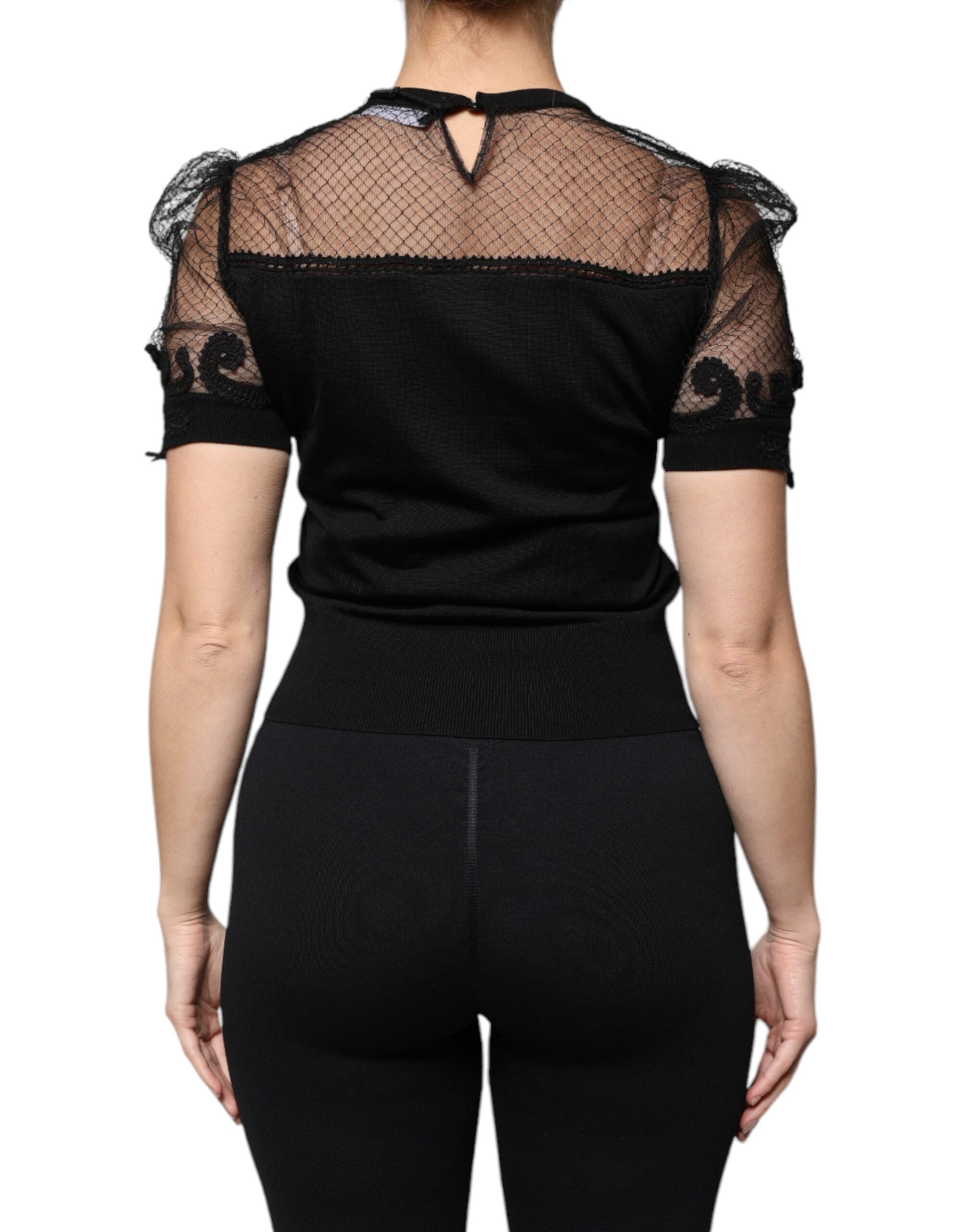 Blouse courte noire en dentelle florale à manches courtes de Dolce & Gabbana, détails élégants et tissu délicat visible.