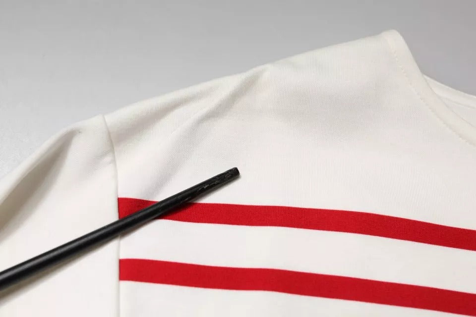 Haut en coton à manches longues Dolce & Gabbana blanc avec rayures rouges, design élégant et confortable.