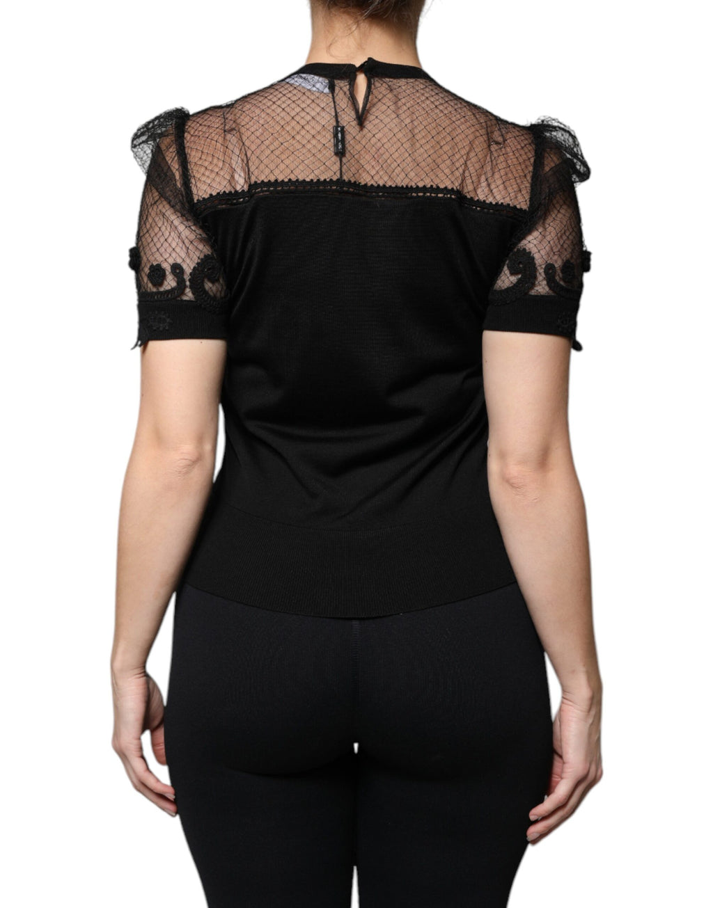 Blouse noire à manches courtes en dentelle florale Dolce & Gabbana, détails élégants et tissu délicat visible sur l'image.