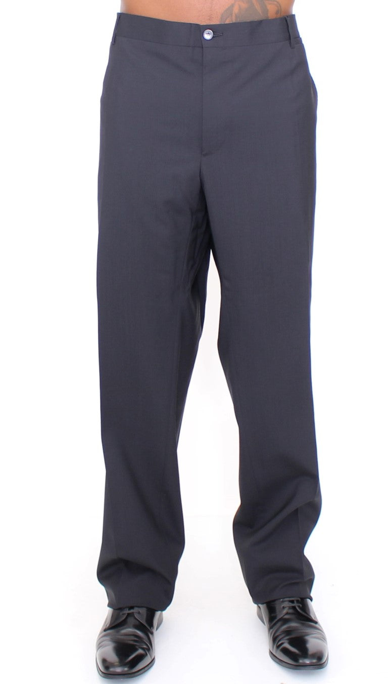 Pantalons plissés en laine noire Dolce & Gabbana, coupe stretch, élégants et modernes, visibles dans cette image.