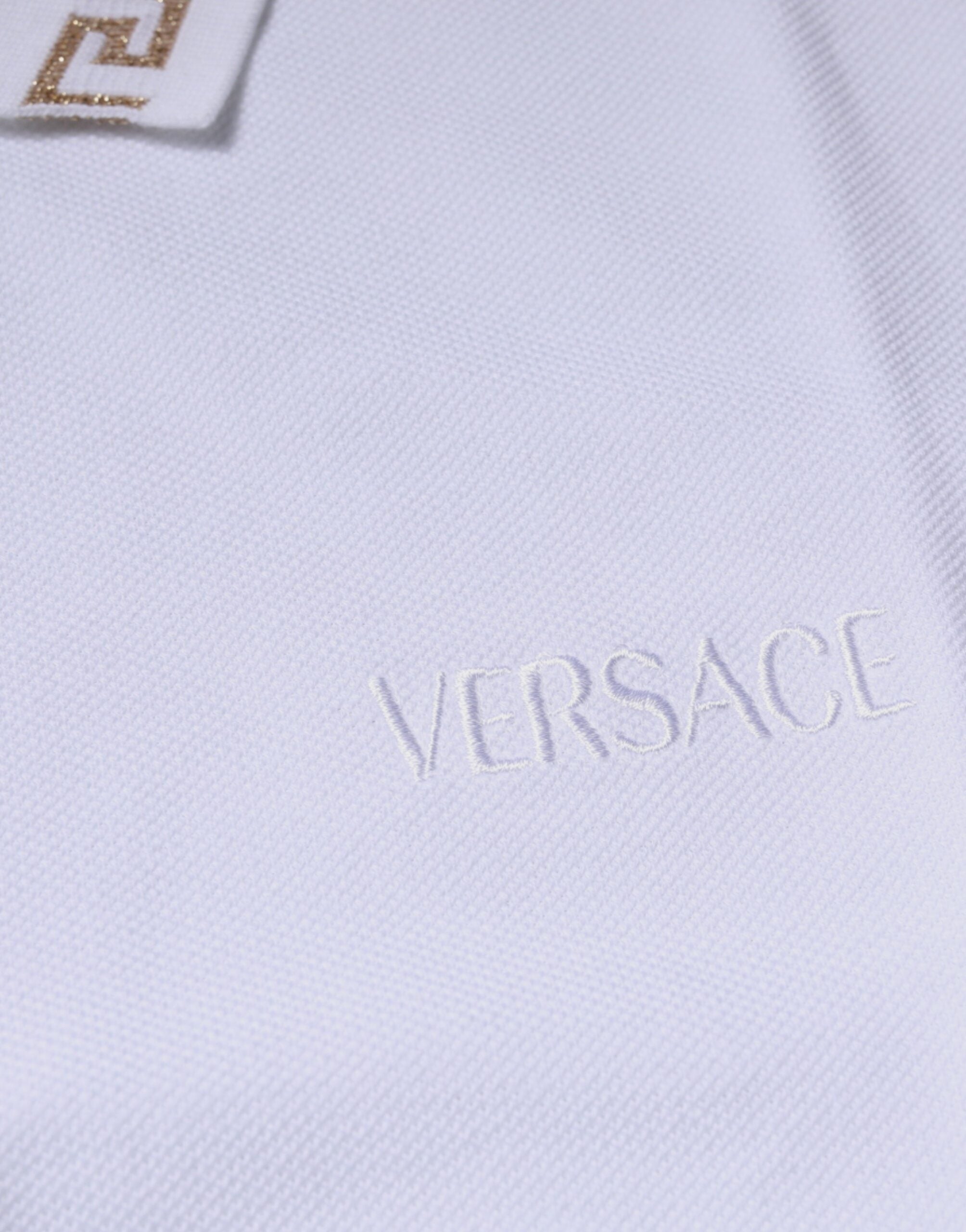 Polo homme à manches courtes blanc en viscose Versace avec col, style élégant et logo distinctif.