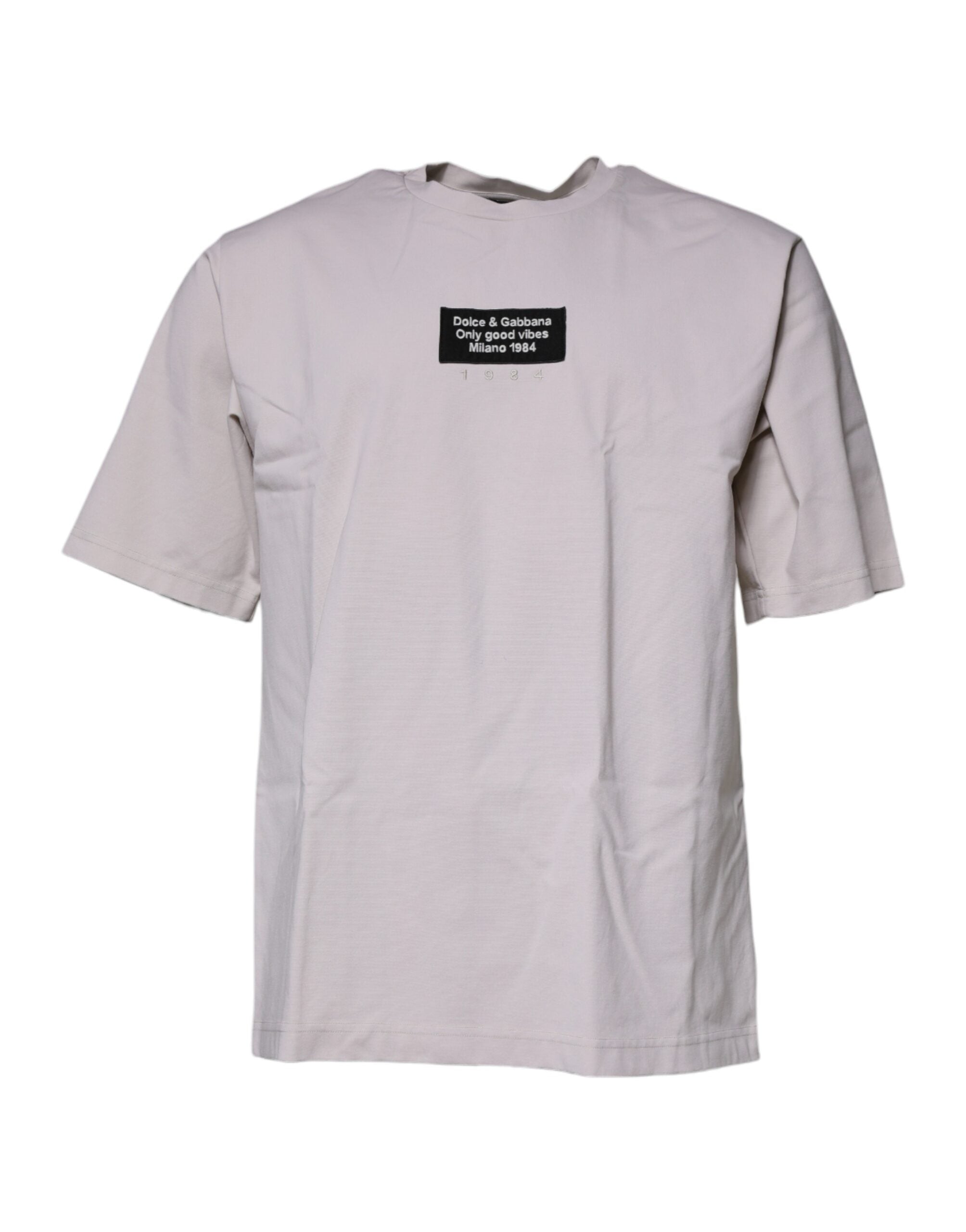T-shirt beige Dolce & Gabbana avec logo DG à col rond et manches courtes, tissu léger et style élégant.