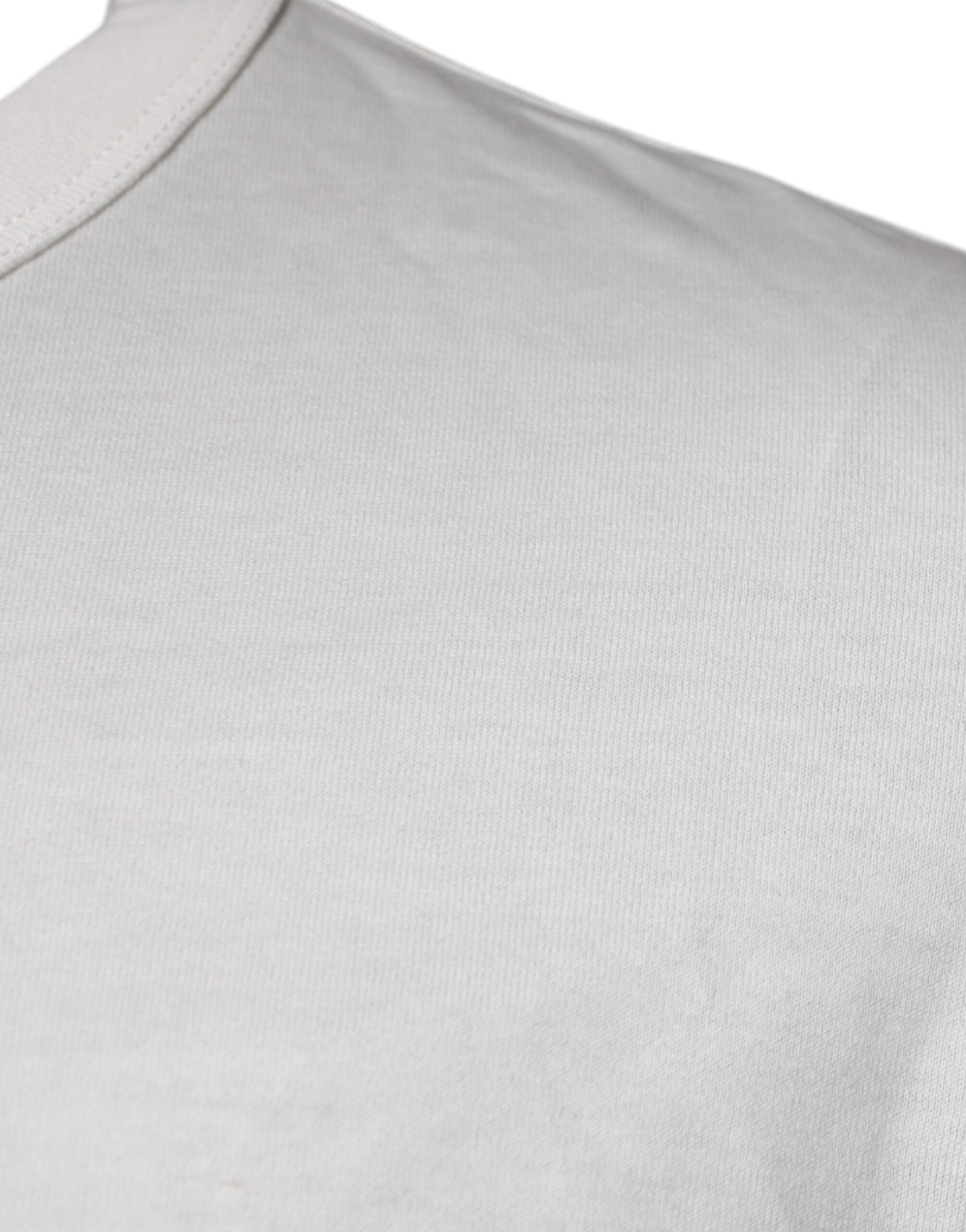 T-shirt blanc Dolce & Gabbana en coton avec logo DG, col rond et design élégant visible sur l'image.