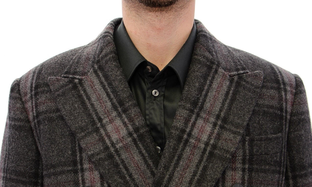 Manteau gris double boutonnage de Dolce & Gabbana, veste élégante en tissu chaud, porté sur un fond neutre.