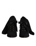 Chaussures Dolce & Gabbana talons aiguilles noires, bottines mi-mollet élégantes et sophistiquées.