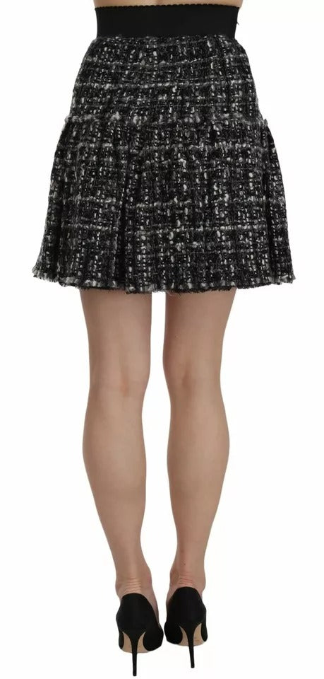 Jupe mini en laine noire à carreaux avec volants et détails sophistiqués de Dolce & Gabbana, mode élégante et tendance.