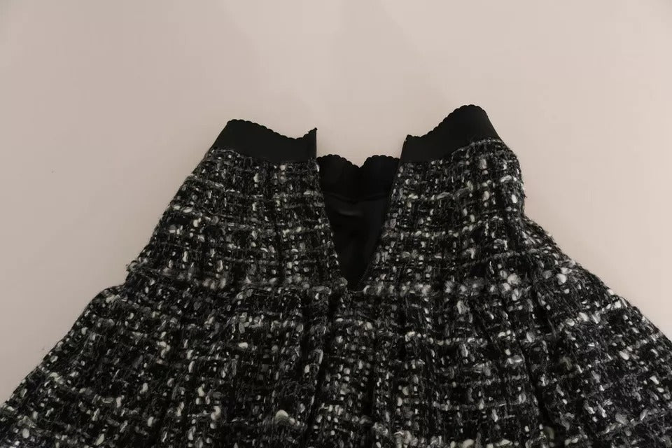 Jupe courte en laine noire à carreaux avec volants, détails sophistiqués, de la marque Dolce & Gabbana.
