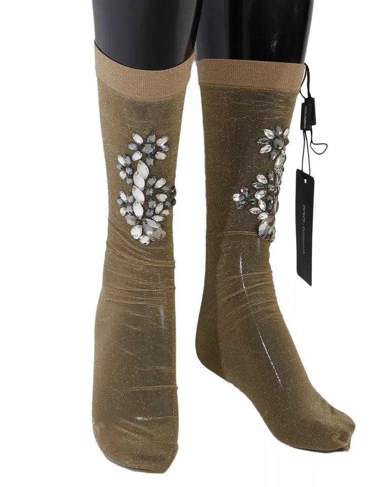 Chaussettes transparentes en dentelle dorée Dolce & Gabbana avec motifs floraux et cristaux clairs, style élégant et sophistiqué.