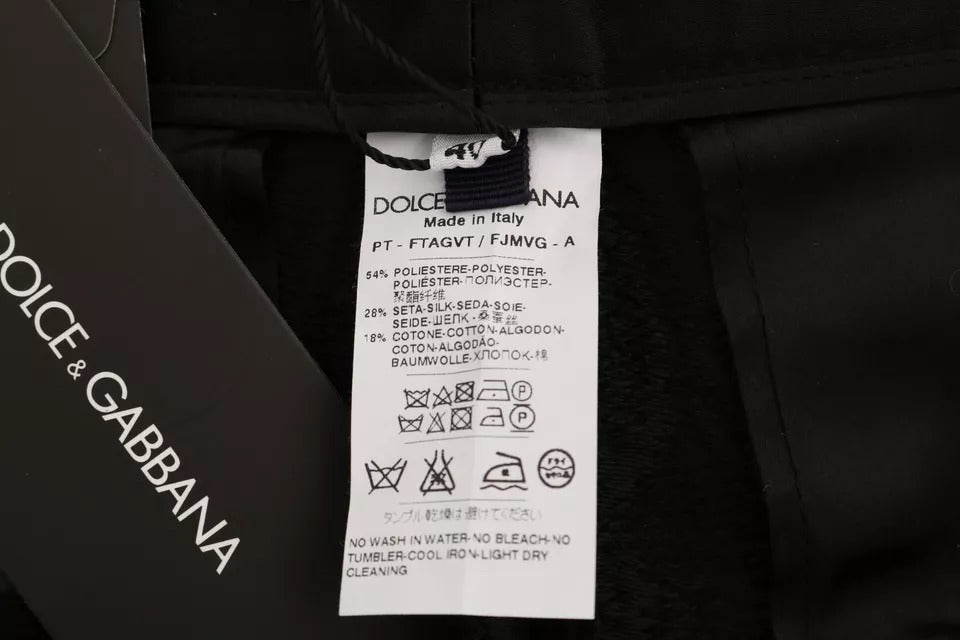 Pantalons en brocart floral noir Dolce & Gabbana à taille haute, élégants et sophistiqués, avec un motif floral riche.