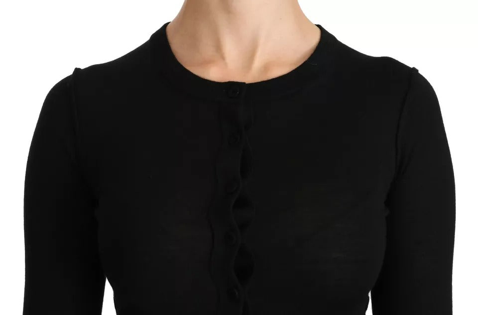 Chemisier noir en laine vierge à manches longues de Dolce & Gabbana, visible avec détails de tissu et coupe élégante.