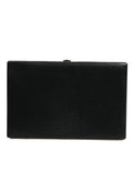 Sac clutch noir en cuir Dolce & Gabbana avec cadre doré, idéal pour soirée ou fête.