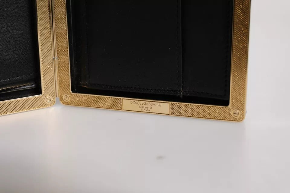 Sac clutch noir en cuir Dolce & Gabbana avec cadre doré, parfait pour soirée et événements élégants.