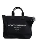 Sac shopping noir en toile Dolce & Gabbana avec logo DG pour femmes, porté sur l'épaule, visible avec poignées en cuir.