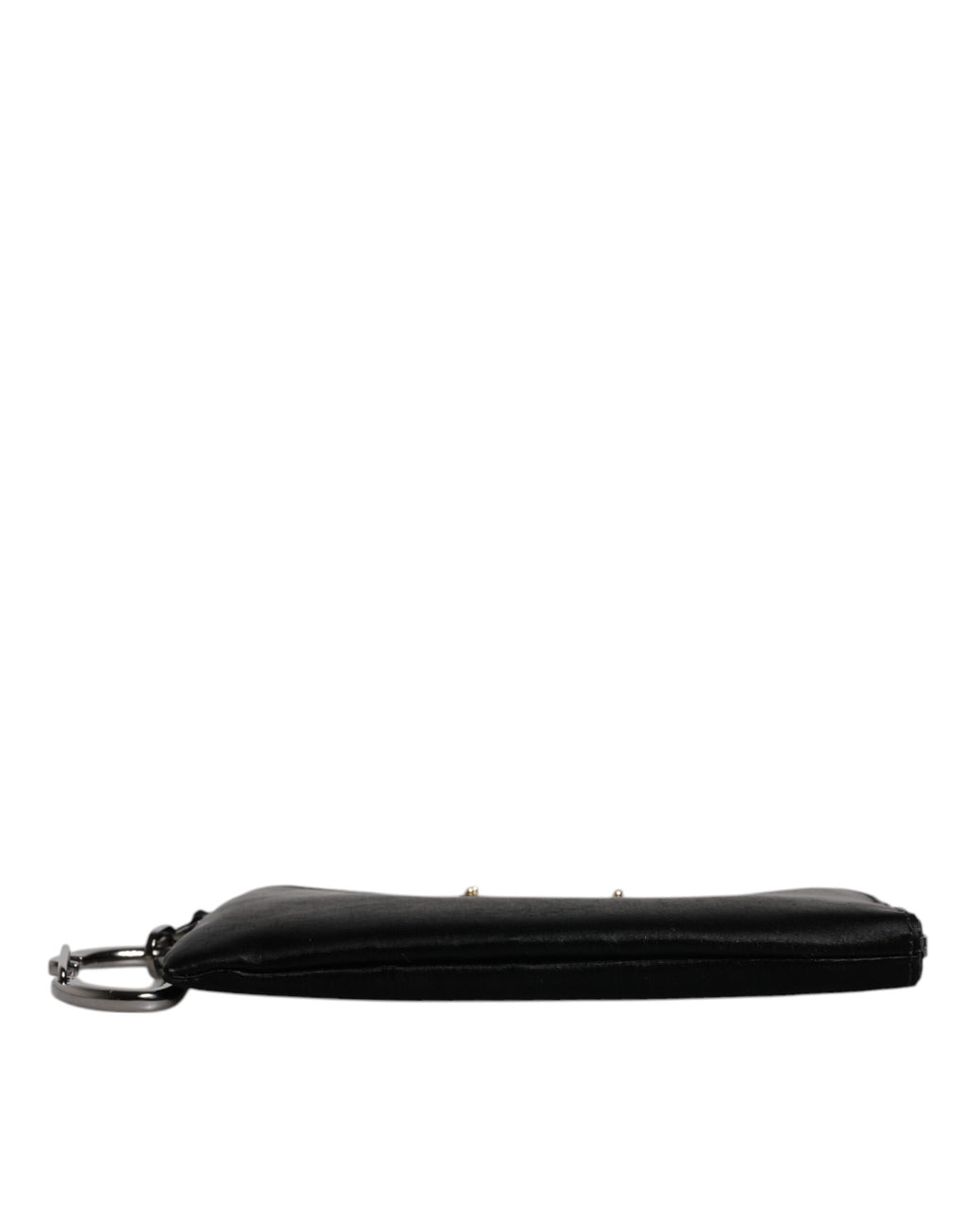 Porte-clés en nylon noir Dolce & Gabbana avec logo en plaque, attaché à une pochette ou clutch élégante.