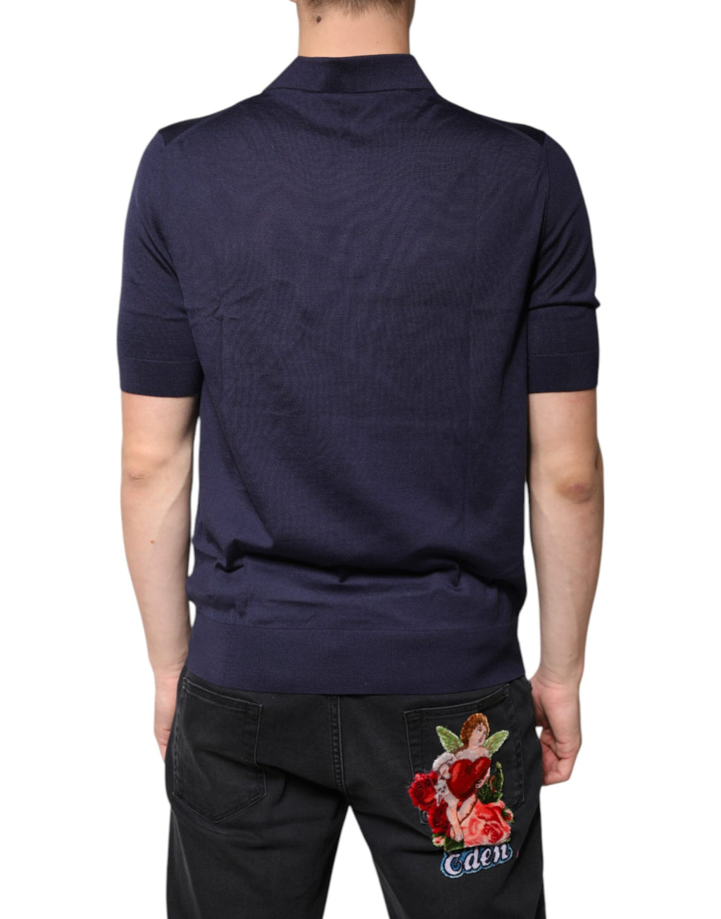 Polo Dolce & Gabbana en soie bleue à col et manches courtes, élégant et sophistiqué, porté sur un mannequin.