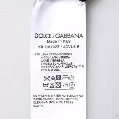Pull en laine noir Dolce & Gabbana avec logo, col rond, style élégant et confortable, visible en détail dans l'image.