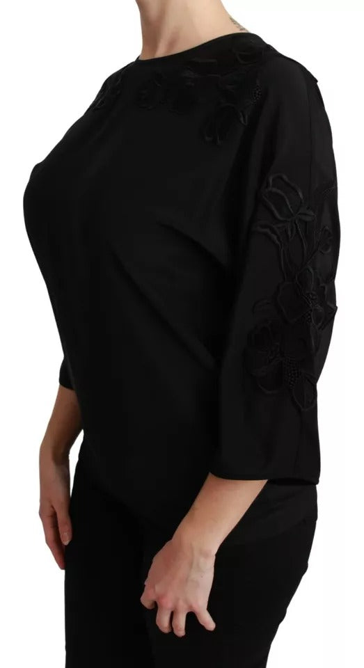 Blouse en soie noire de Dolce & Gabbana avec broderies florales élégantes et détails sophistiqués.