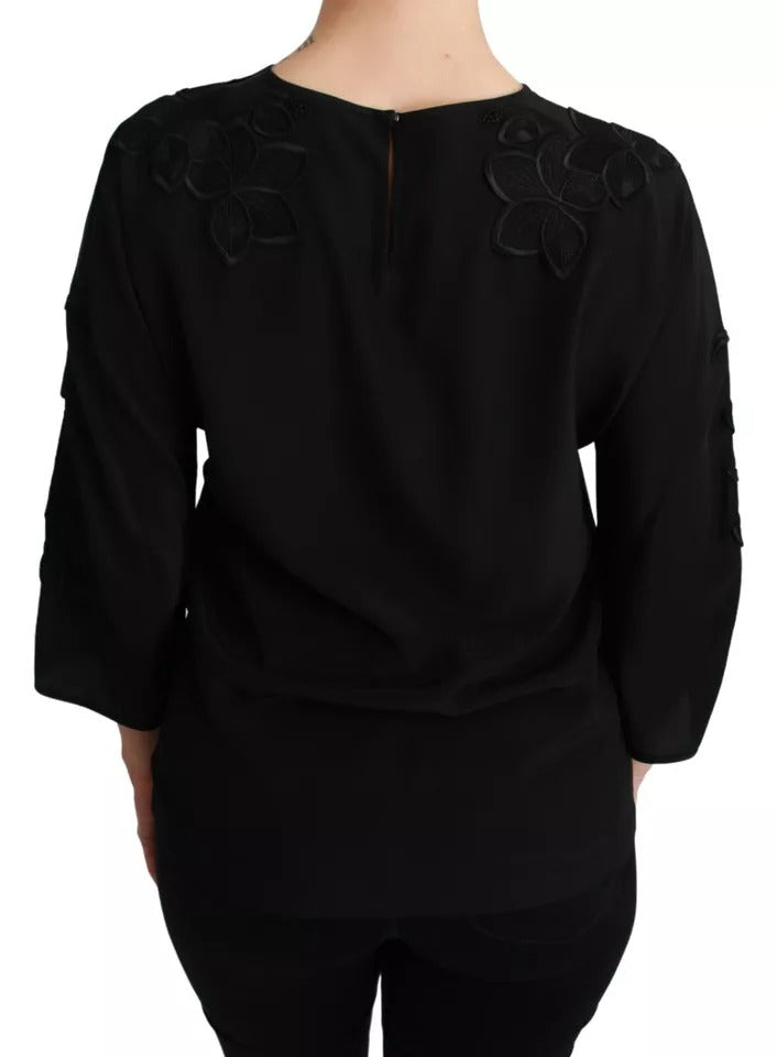 Blouse en soie noire Dolce & Gabbana avec broderie florale élégante et détails raffinés.
