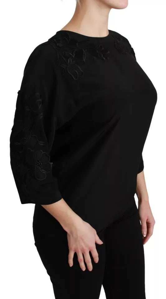 Blouse en soie noire Dolce & Gabbana avec broderie florale élégante, manche longue et coupe fluide.