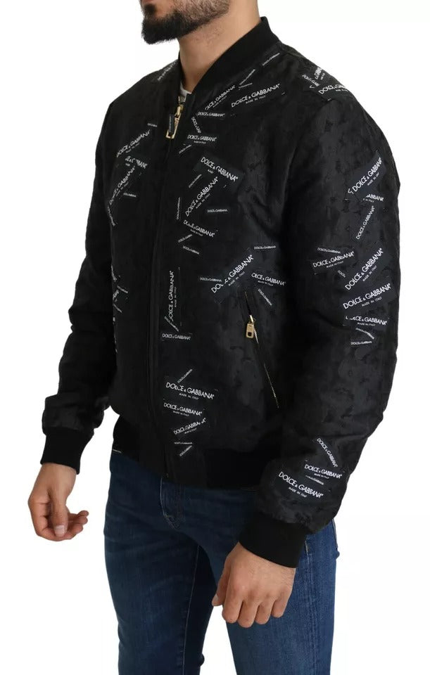 Veste bomber Dolce & Gabbana noire avec patch logo brodé, fermeture éclair complète, style élégant et tendance pour homme.