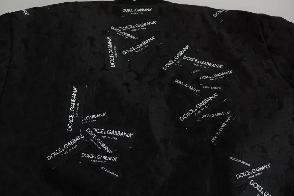Veste bomber Dolce & Gabbana noire avec patch logo en brocart, fermeture éclair complète, style élégant et tendance.