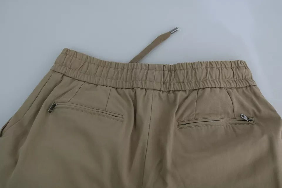 Pantalons cargo beige Dolce & Gabbana avec imprimé Pin Up, style tendance, détails visibles sur le vêtement.