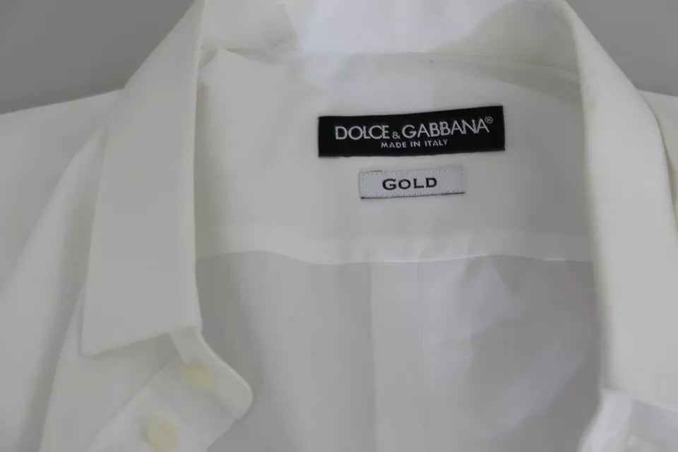 Haut de costume en coton blanc Dolce & Gabbana avec détails dorés, élégant et sophistiqué pour occasion formelle.