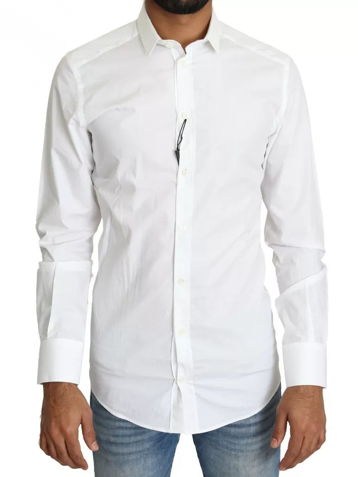 Haut blanc en coton formel de Dolce & Gabbana avec détails dorés, élégant et sophistiqué, porté comme chemise ou top chic.