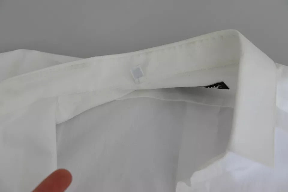 Haut blanc en coton formel Dolce & Gabbana avec détails dorés, élégant et sophistiqué pour occasion spéciale.