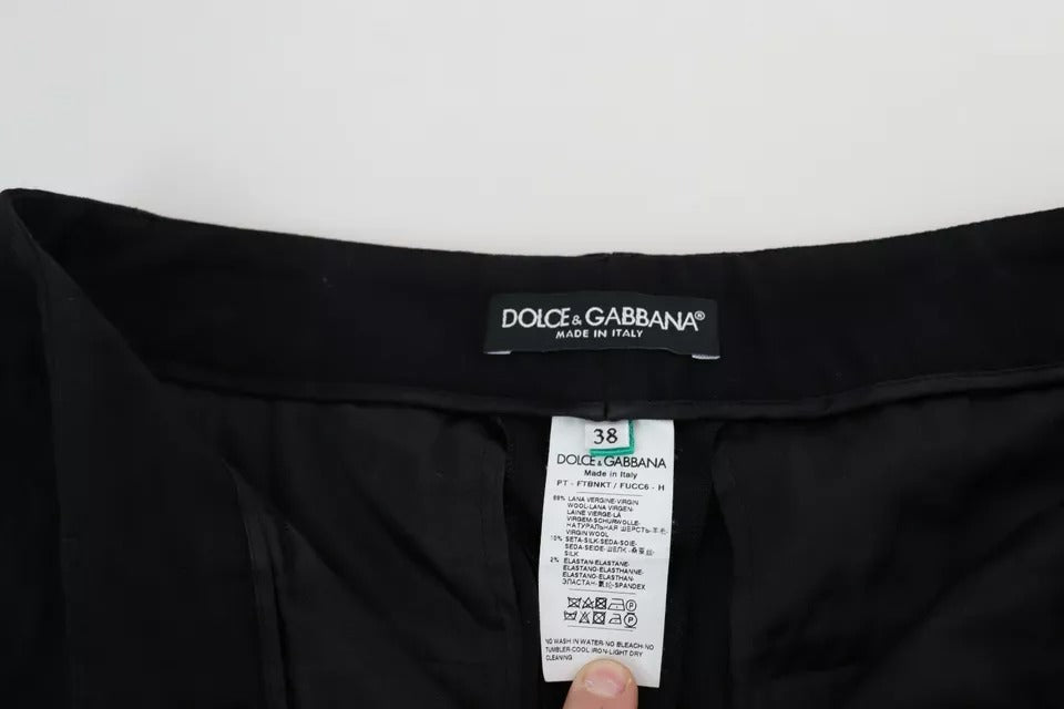 Pantalons skinny en laine vierge noire Dolce & Gabbana, coupe stretch, style élégant et moderne, visibles en gros plan.