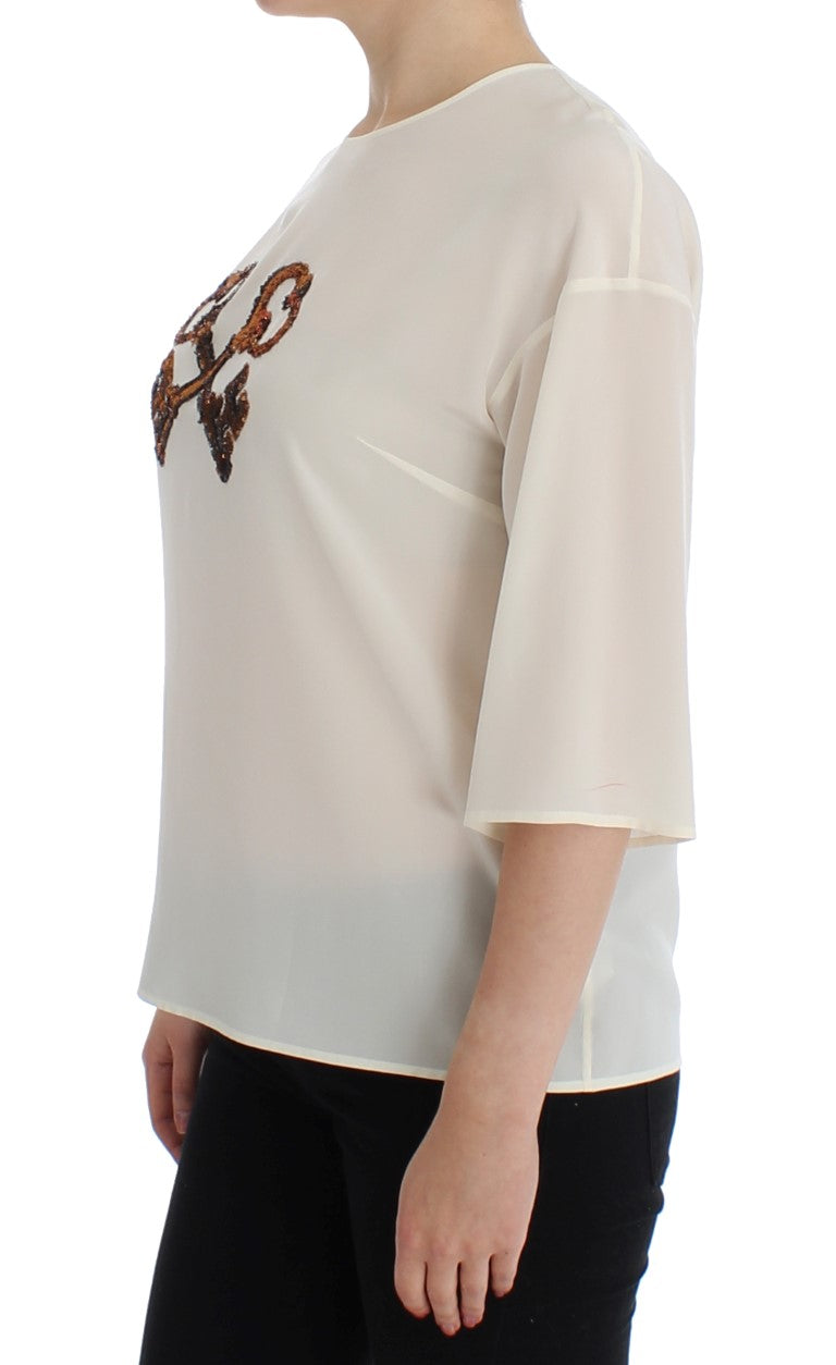 T-shirt blanc Dolce & Gabbana en soie avec sequins, style blouse élégante et sophistiquée.