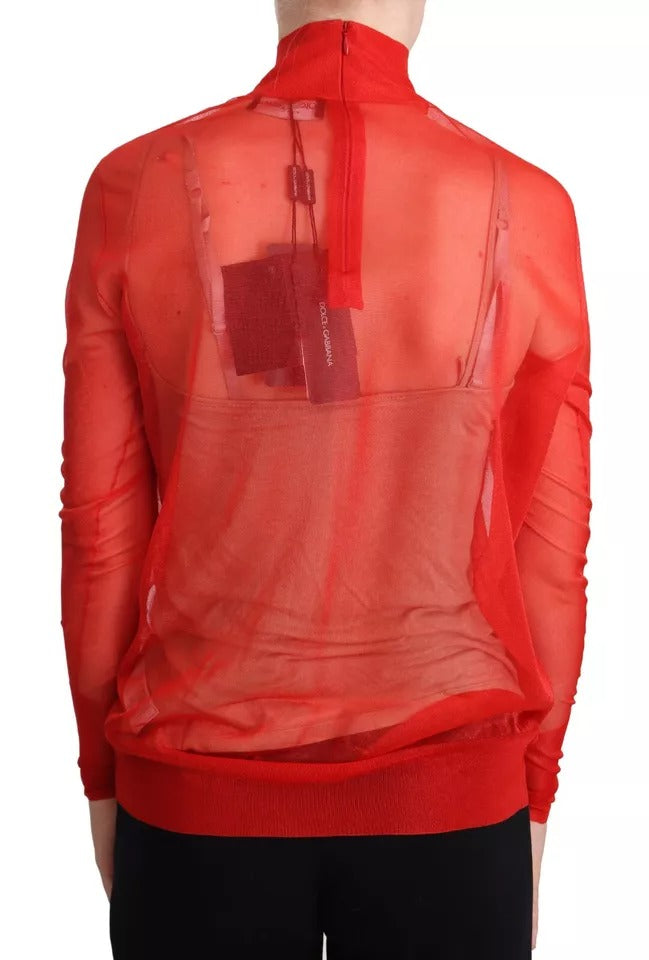 Pull à manches longues Dolce & Gabbana orange semi-transparent, en tissu léger et élégant, porté sur un mannequin.