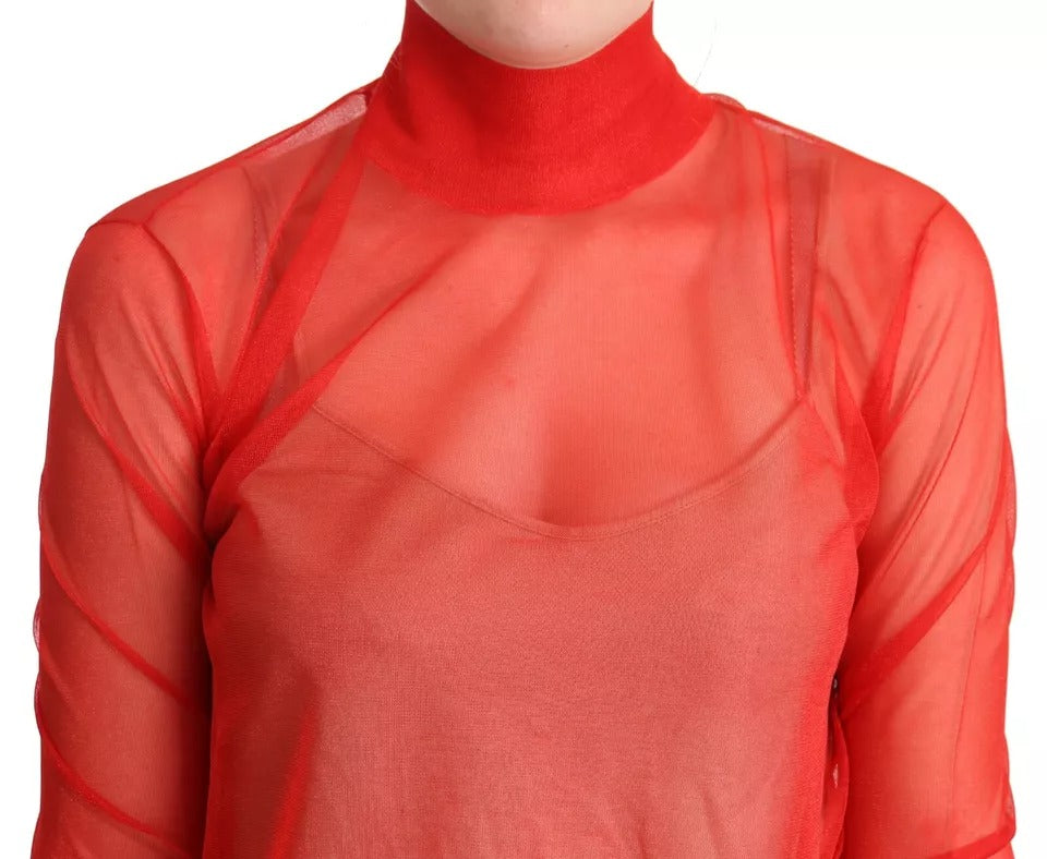 Pull en blouse semi-transparent orange Dolce & Gabbana avec détails délicats, porté élégant et moderne.