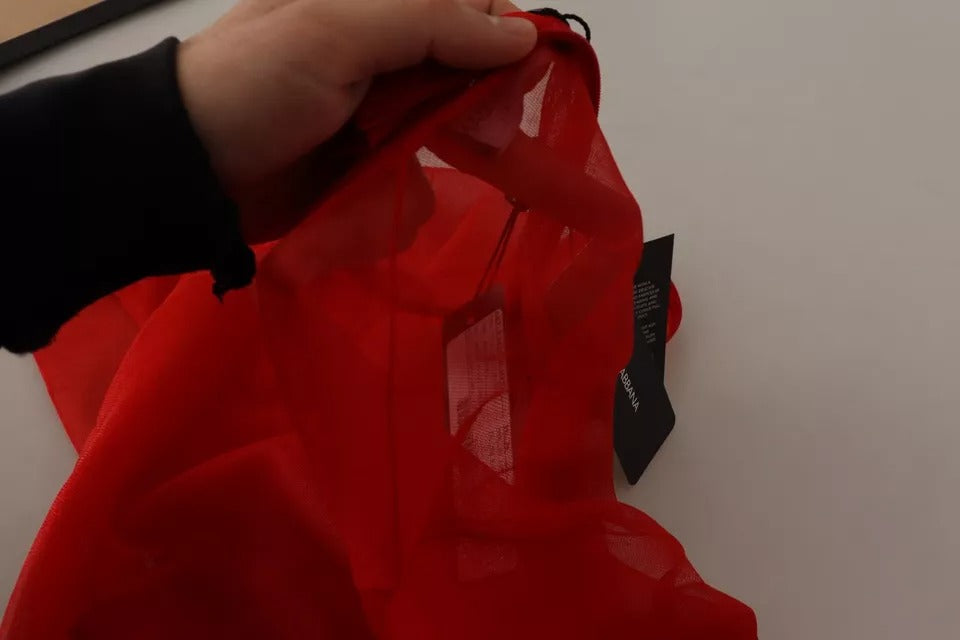 Pull en blouse semi-transparent orange Dolce & Gabbana avec manches longues et détail élégant, porté sur un mannequin.