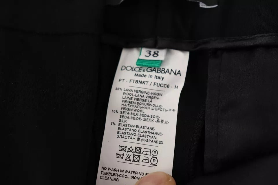 Pantalon en laine noir et blanc à rayures, coupe tapered de Dolce & Gabbana, visible en gros plan.