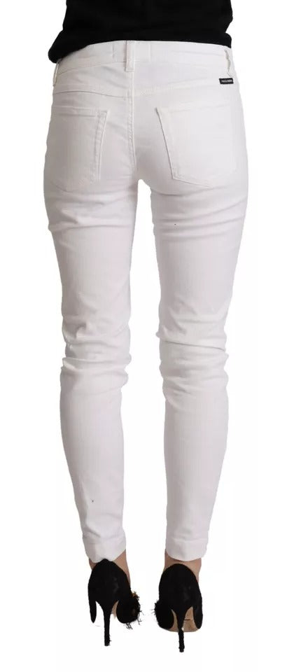 Jeans slim blanc en denim en coton de Dolce & Gabbana, coupe élégante et ajustée, visibles avec détails et texture du tissu.