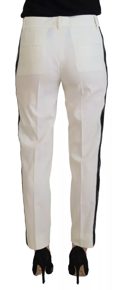 Pantalon en laine blanche à taille haute et coupe tapered de Dolce & Gabbana, visible en gros plan sur la photo.