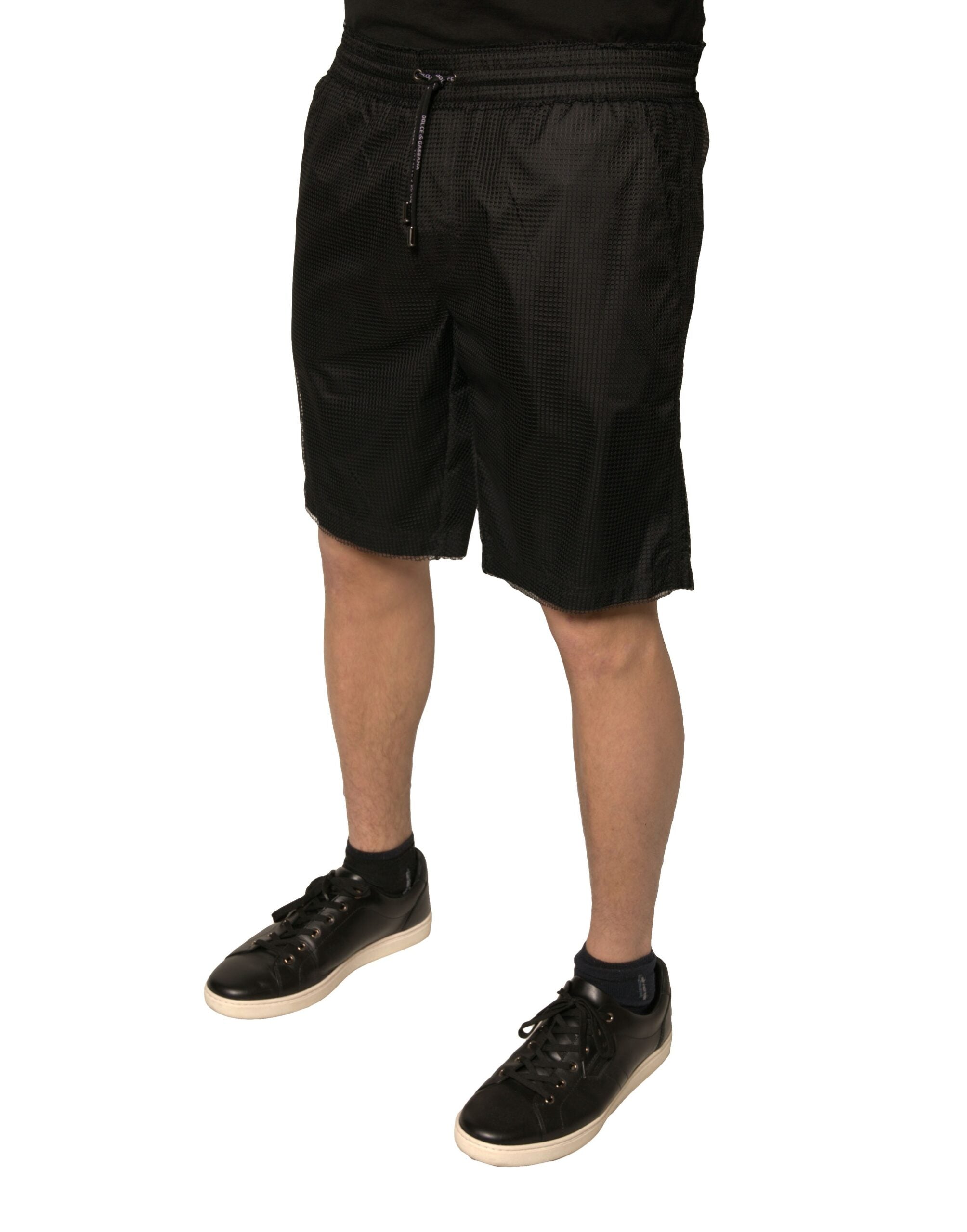 Shorts Dolce & Gabbana en polyester jersey noir, taille moyenne et coupe décontractée, parfaits pour un style élégant et confortable.