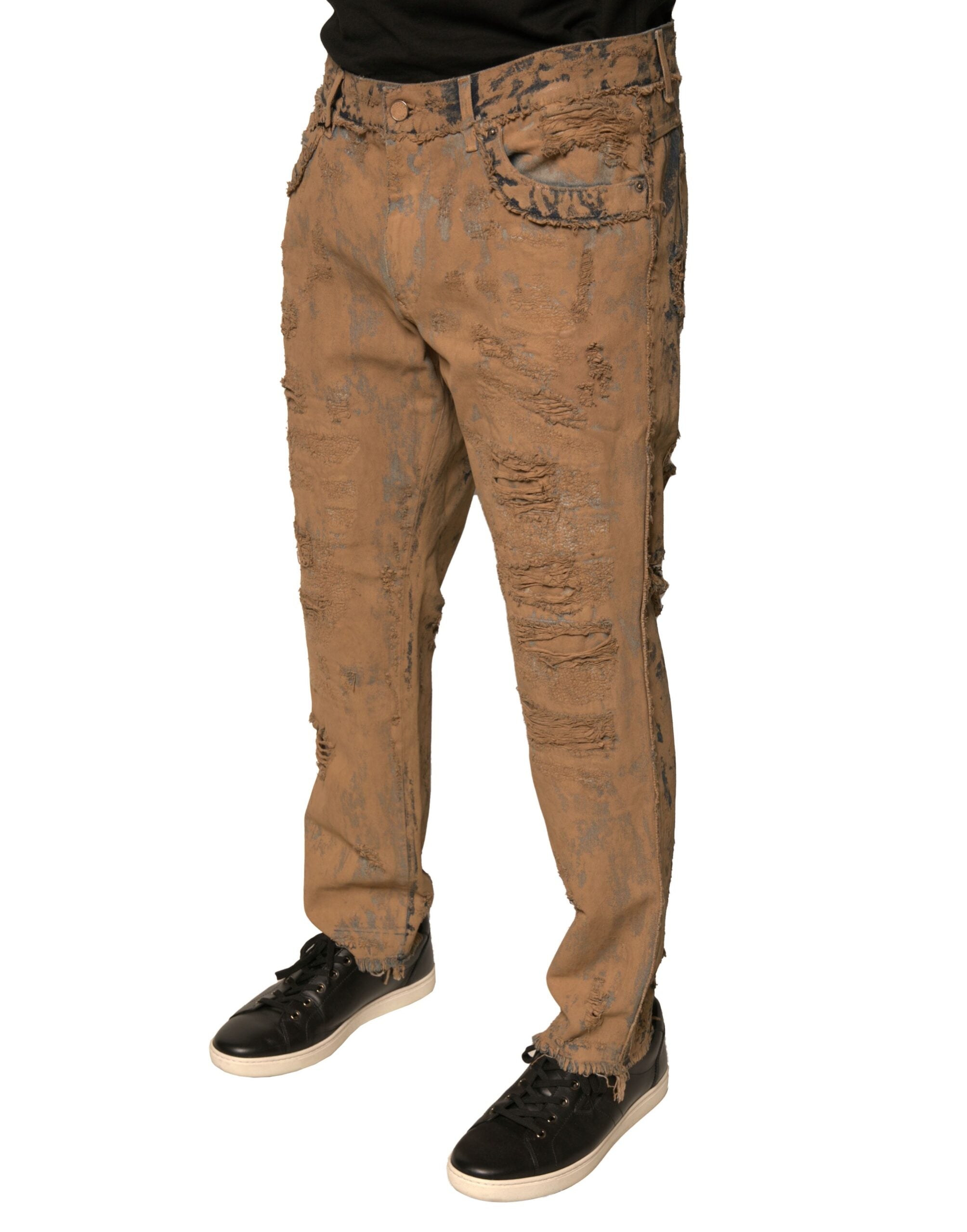 Jean skinny en denim de coton marron tacheté de Dolce & Gabbana, style déchiré et tendance, visible en gros plan.