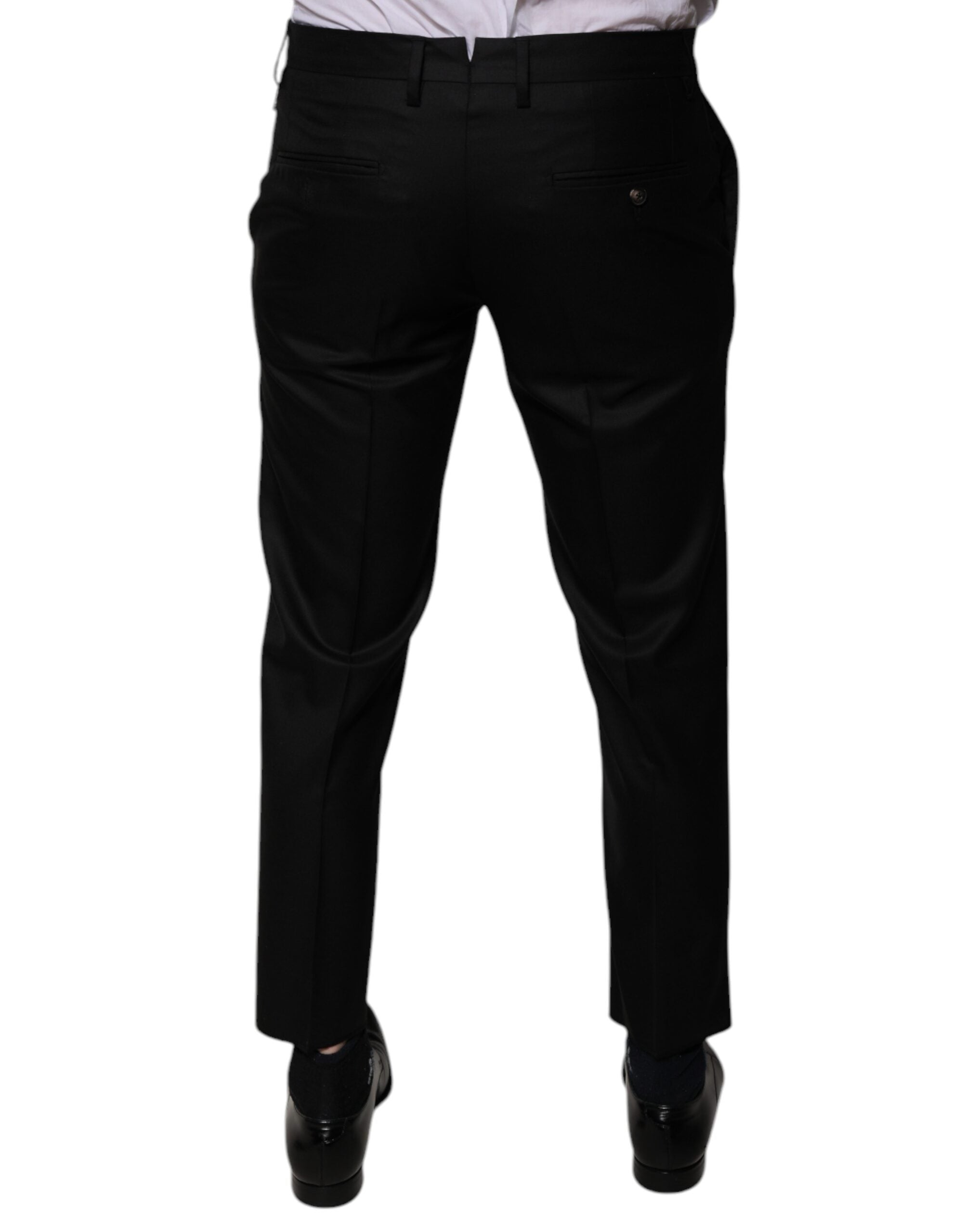 Pantalon de costume noir en laine Dolce & Gabbana, coupe tapered, style formel, visible détail de la texture de la laine.