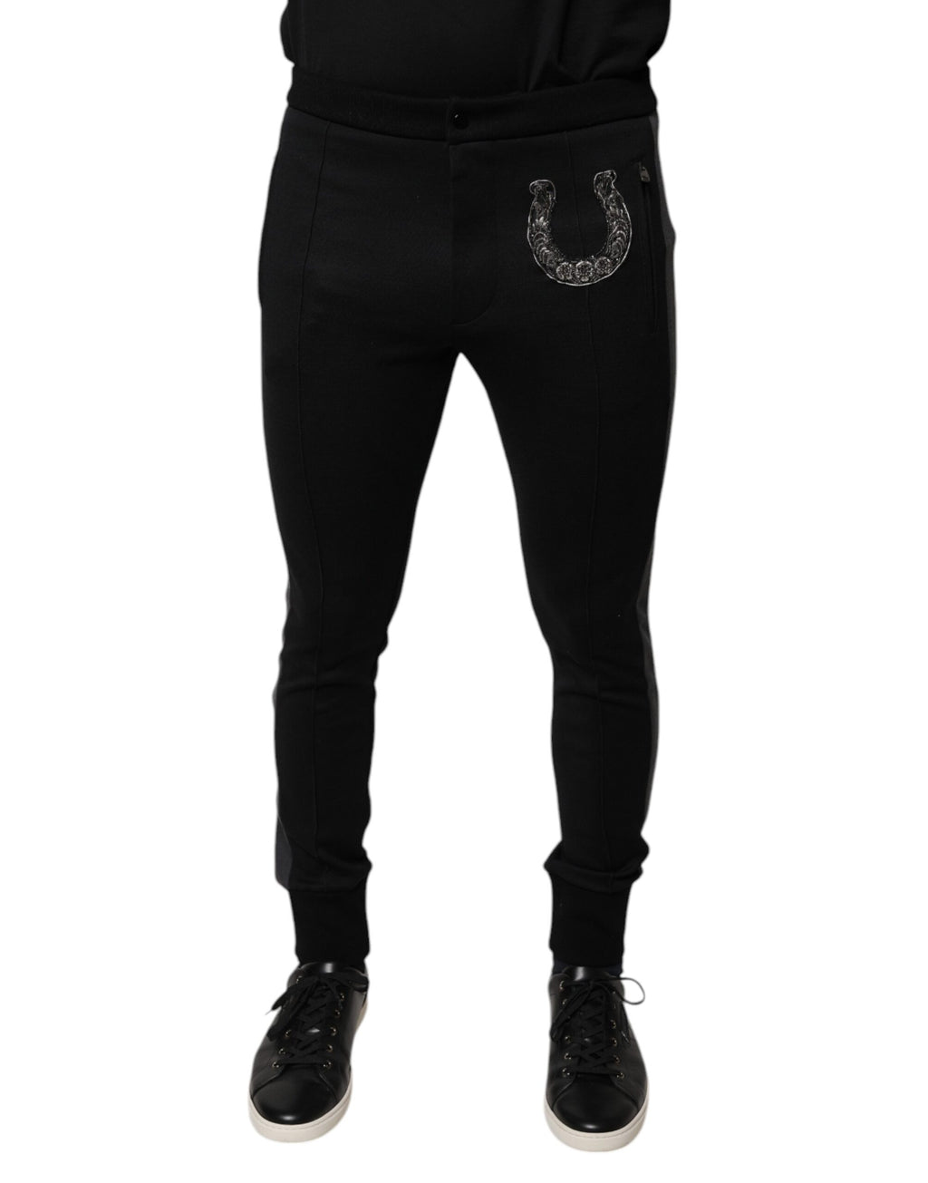 Pantalon slim en laine noir Dolce & Gabbana avec embellissements en fer à cheval, coupe élégante et détails sophistiqués.