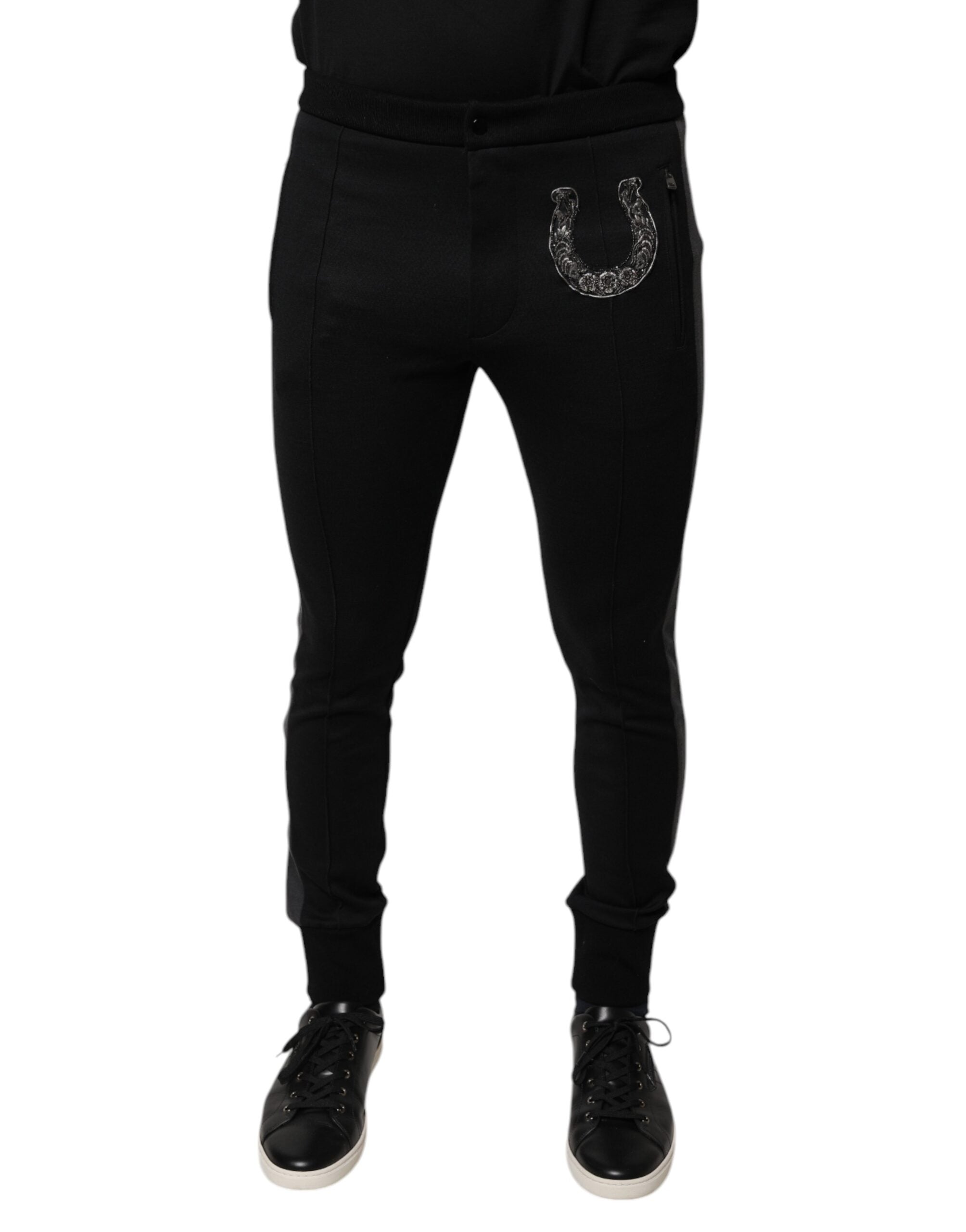 Pantalon slim en laine noir Dolce & Gabbana avec embellissements en fer à cheval, coupe élégante et détails sophistiqués.