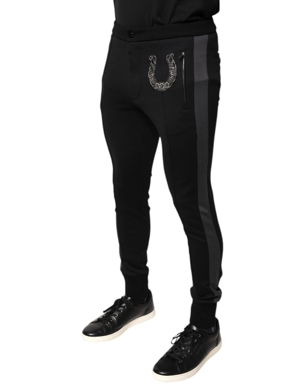 Pantalons slim en laine noirs Dolce & Gabbana ornés de ferrures en forme de fer à cheval, élégants et sophistiqués.