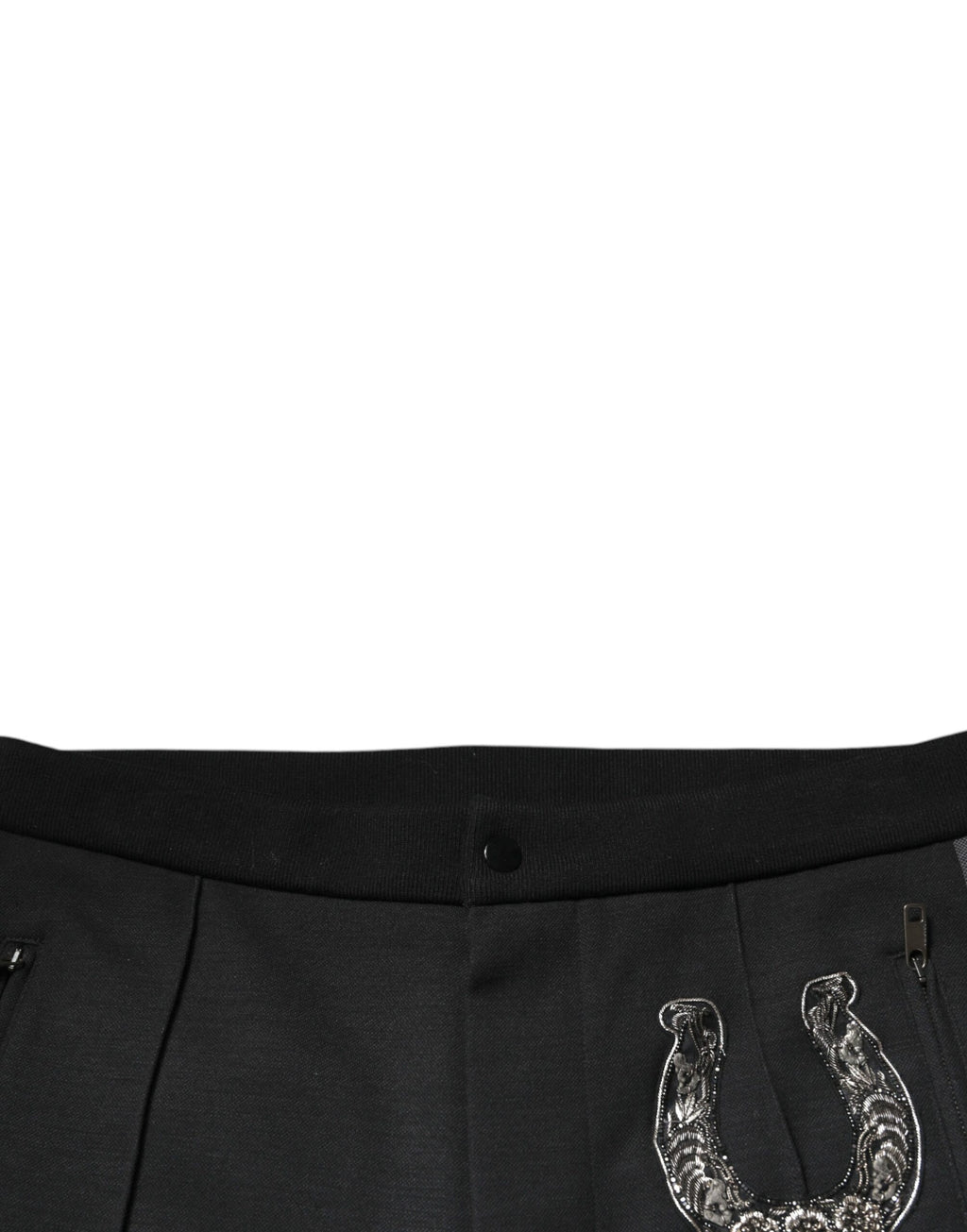 Pantalon slim en laine noir Dolce & Gabbana avec embellissements en forme de fer à cheval, ajusté et élégant.