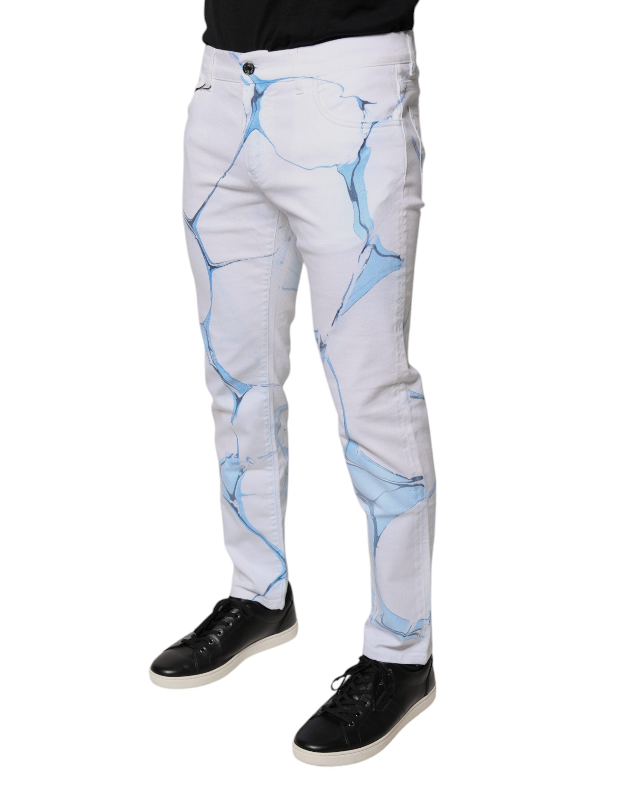 Jeans skinny en denim coton stretch blanc et bleu de Dolce & Gabbana, vue détaillée avec coutures et bouton.